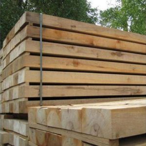 "Stack of durable oak sleepers, perfect for garden landscaping, raised beds, and outdoor construction projects."
