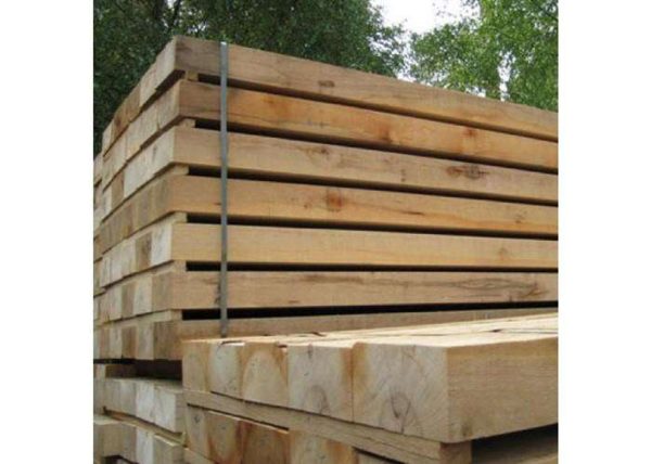 "Stack of durable oak sleepers, perfect for garden landscaping, raised beds, and outdoor construction projects."